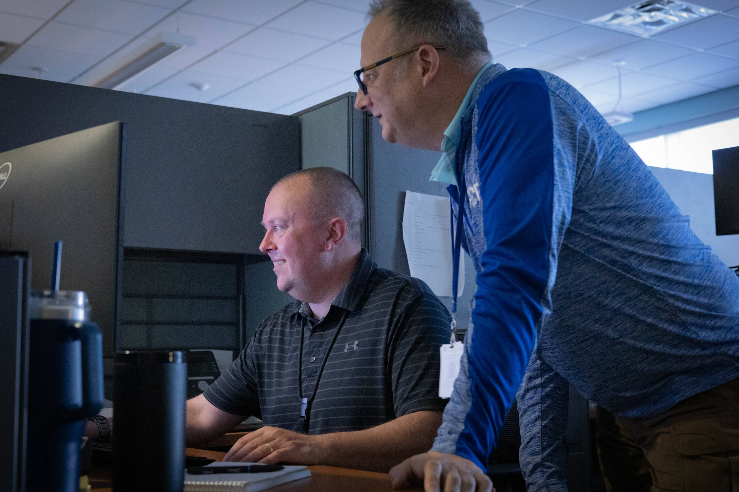 Two men looking at a computer screen in an office