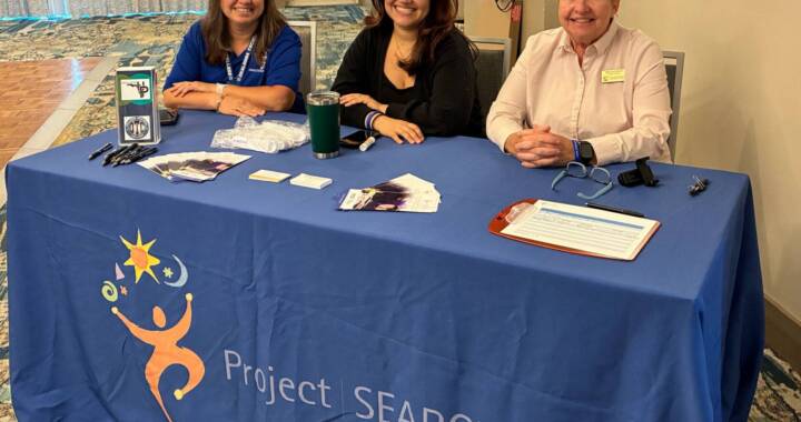 Project SEARCH representatives sitting behind the sign in table at a hiring event