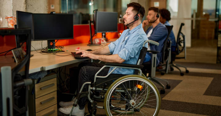 man working in IT, programming in wheelchair