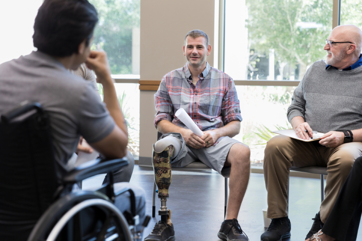 Veteran wearing prosthetic in a group discussion