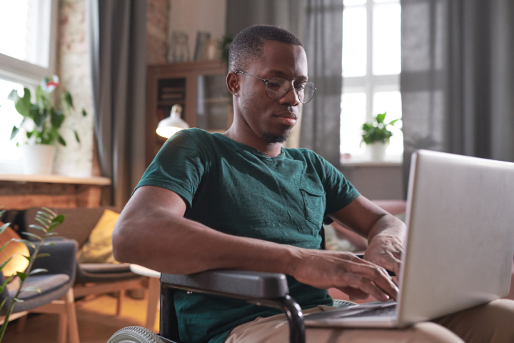 Man typing on laptop while working from home