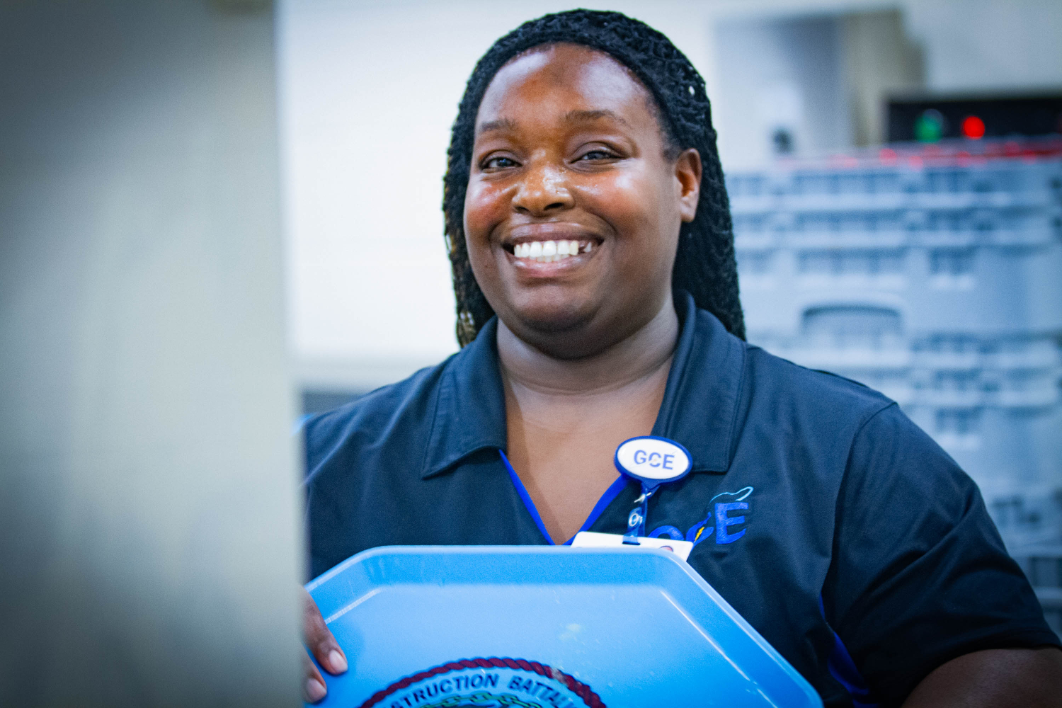 Food service worker loading trays for cleaning