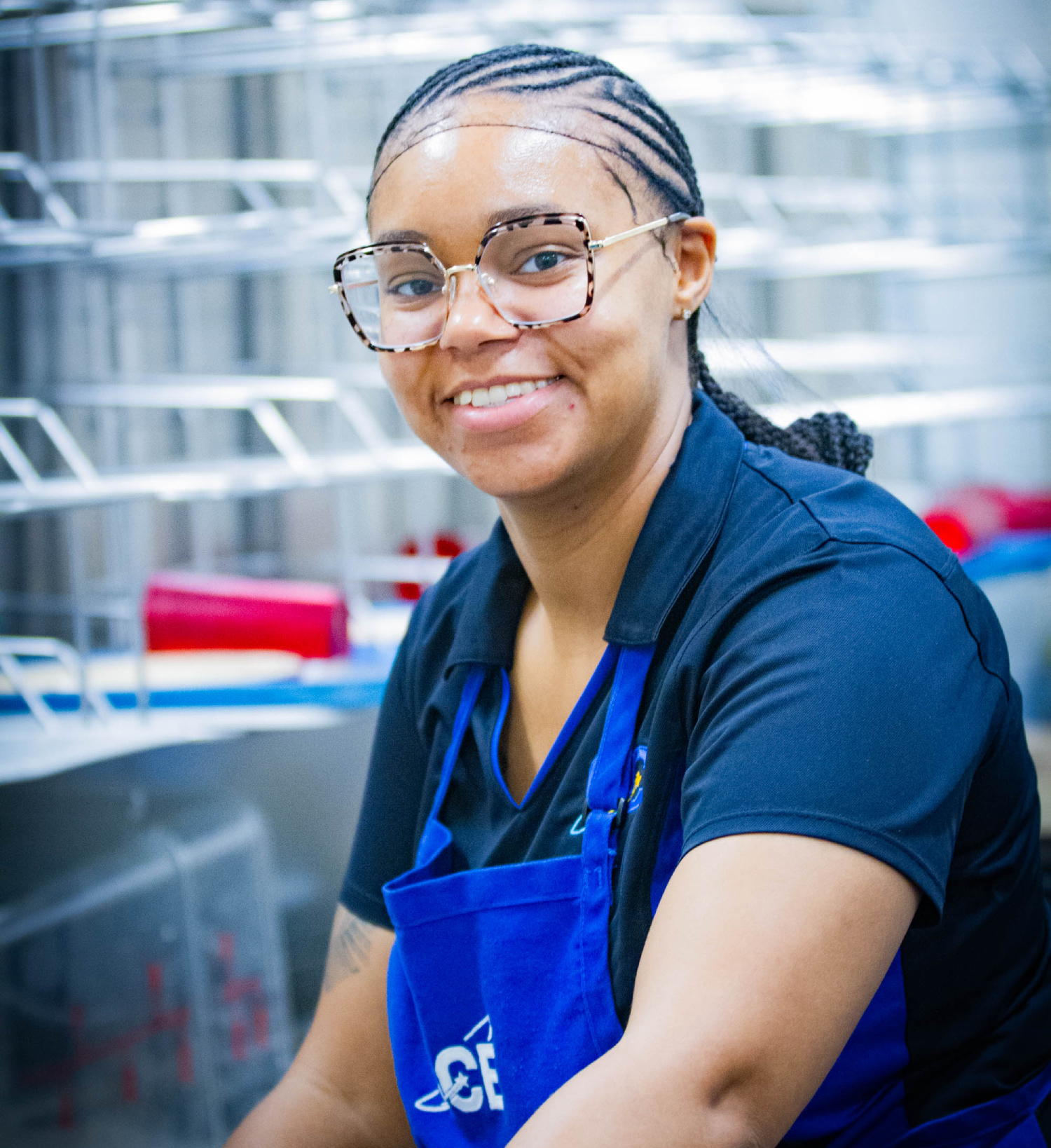 Food service worker loading dishes and trays for cleaning