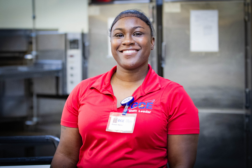 Food service supervisor smiling in kitchen